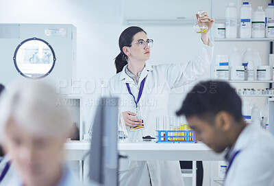 Buy stock photo Shot of a group of scientists working together