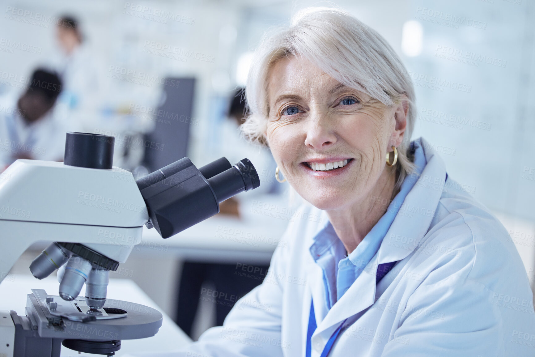 Buy stock photo Microscope, mature woman and portrait in lab, biotechnology and smile for science and healthcare. Proud, medical research and process for medicine, person and cure for mpox, scientist and Denmark