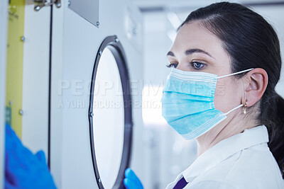 Buy stock photo Shot of a young female lab worker waiting for a test sample
