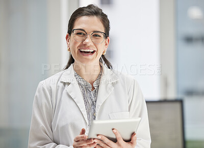 Buy stock photo Shot of a happy young doctor using a digital tablet