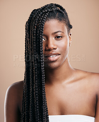 Buy stock photo Cropped portrait of an attractive young woman posing in studio against a brown background