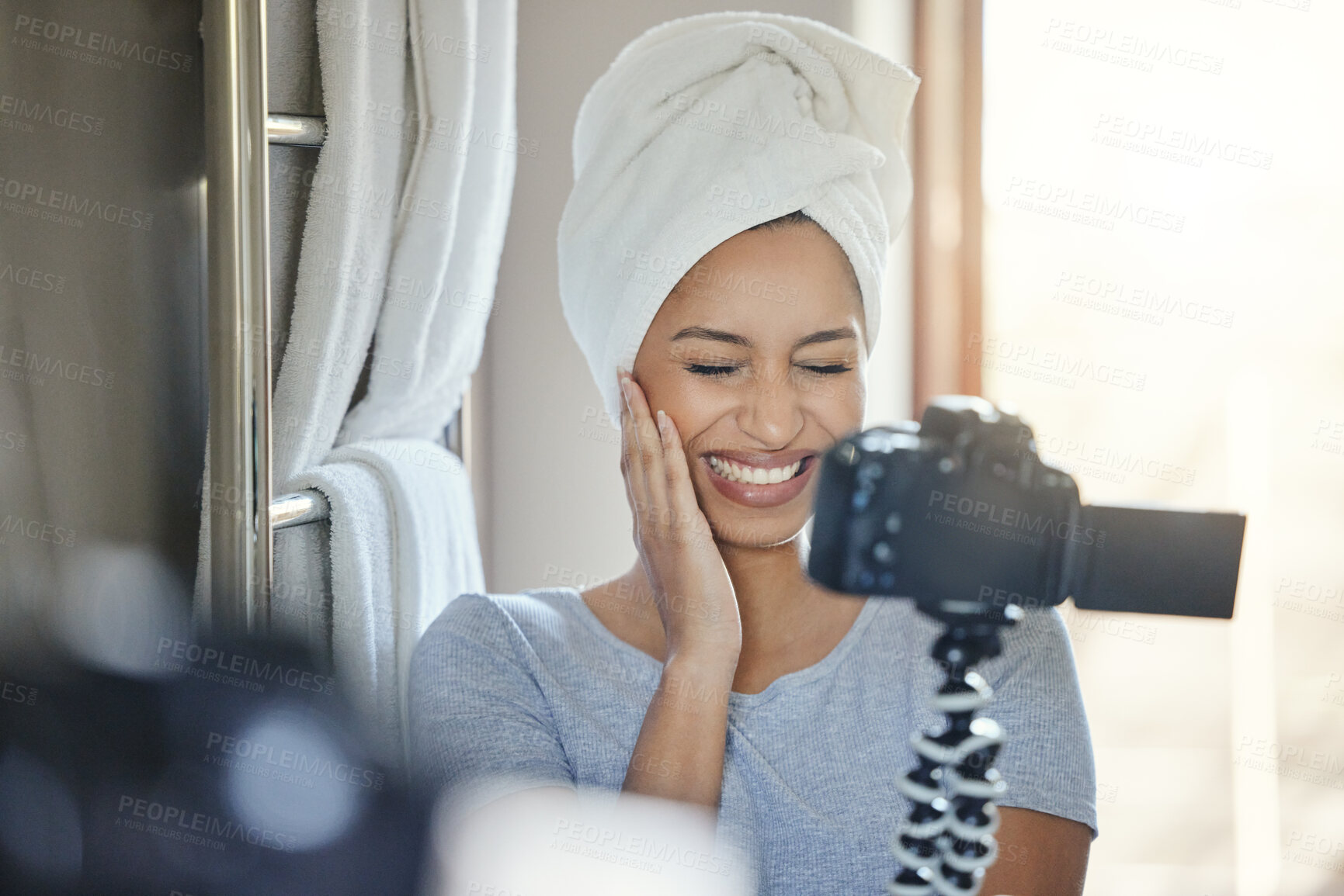 Buy stock photo Shot of a young woman recording herself getting ready at home