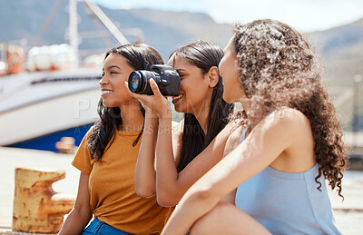 Buy stock photo Camera, travel and group of friends on harbor for photography on vacation, adventure or getaway. Explore, sightseeing and women with dslr equipment for memory on holiday or weekend trip together.