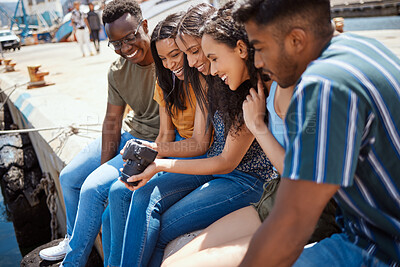 Buy stock photo Friends, camera and happy on dock for travel, fun memories and excited on outdoor journey. People, digital technology and laugh on harbor for content creation, social media photography and reunion