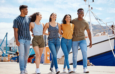 Buy stock photo Friends, laugh and walking on dock for travel, journey and excited for new adventure on sea. People, happy and boats at harbor for summer vacation, holiday reunion and support with group diversity