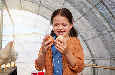 Buy stock photo Shot of an adorable little girl holding eggs in a chicken coop