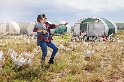 Buy stock photo Shot of a woman bonding with her daughter on a poultry farm