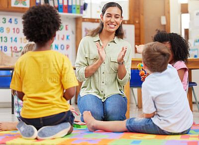 Buy stock photo Diversity, teacher with children at school and playing together in a classroom at. Teaching or learning, education or collaboration and happy female person with preschool kids play on floor in class