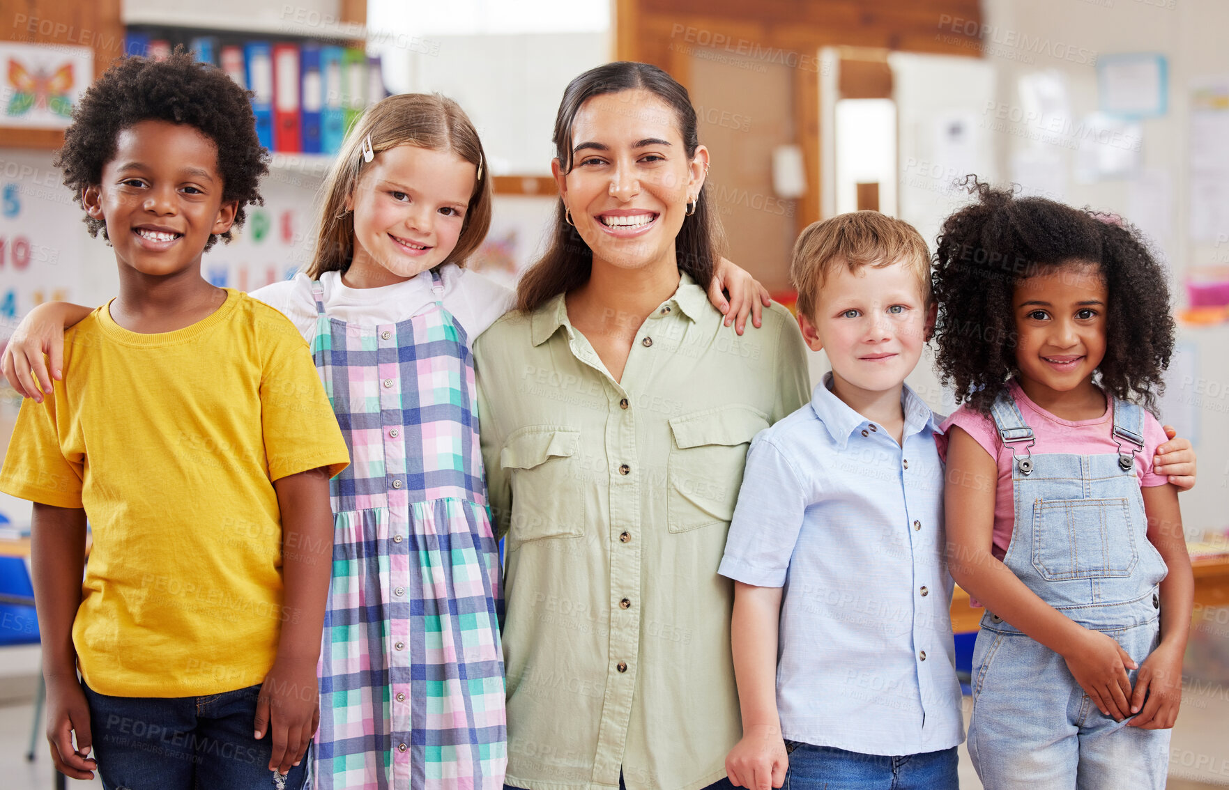 Buy stock photo Education, portrait of teacher with children and in a classroom of a school. Diversity or support, happiness or caring and smiling female person with kids at kindergarten in a class together.