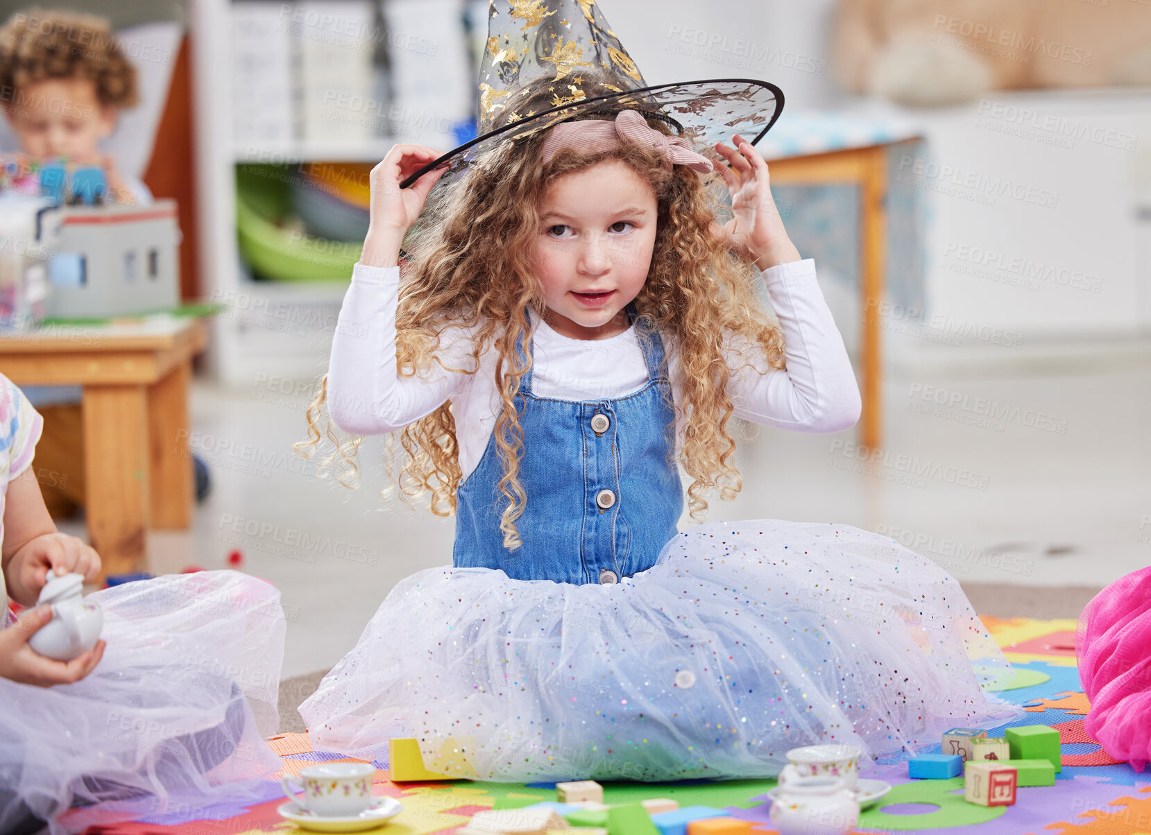 Buy stock photo Shot of a little girl playing dress-up in class