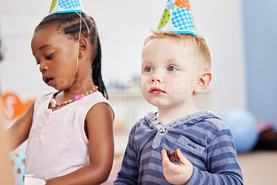 Buy stock photo Boy, eating and birthday cake in classroom, party and celebration with friends at kindergarten. Kids, hat and support with plate for dessert, snack and food with sweets for event, creche and school