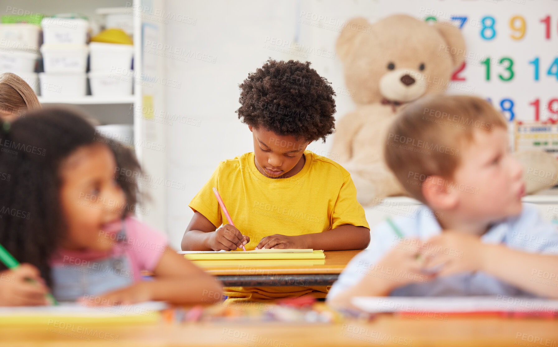 Buy stock photo Shot of preschool students colouring in class