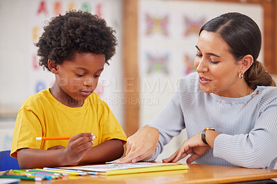 Buy stock photo Shot of a female teacher assisting a preschool learner in her class