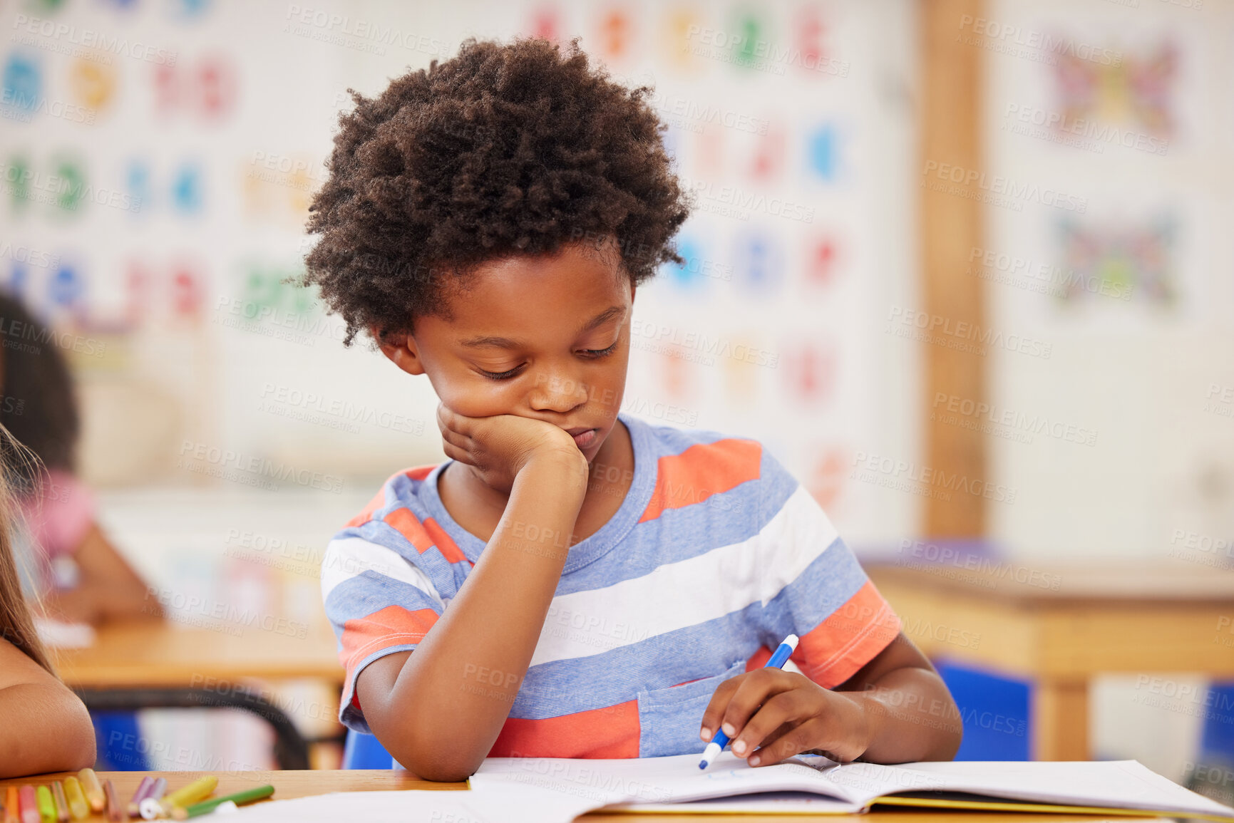 Buy stock photo Shot of a preschooler colouring in class