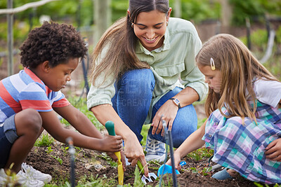 Buy stock photo Cropped shot of an attractive young woman and two adorable little kids working on a farm