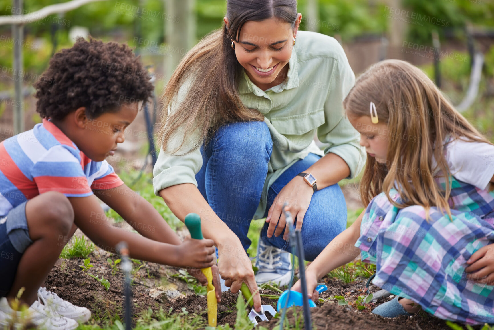 Buy stock photo Cropped shot of an attractive young woman and two adorable little kids working on a farm