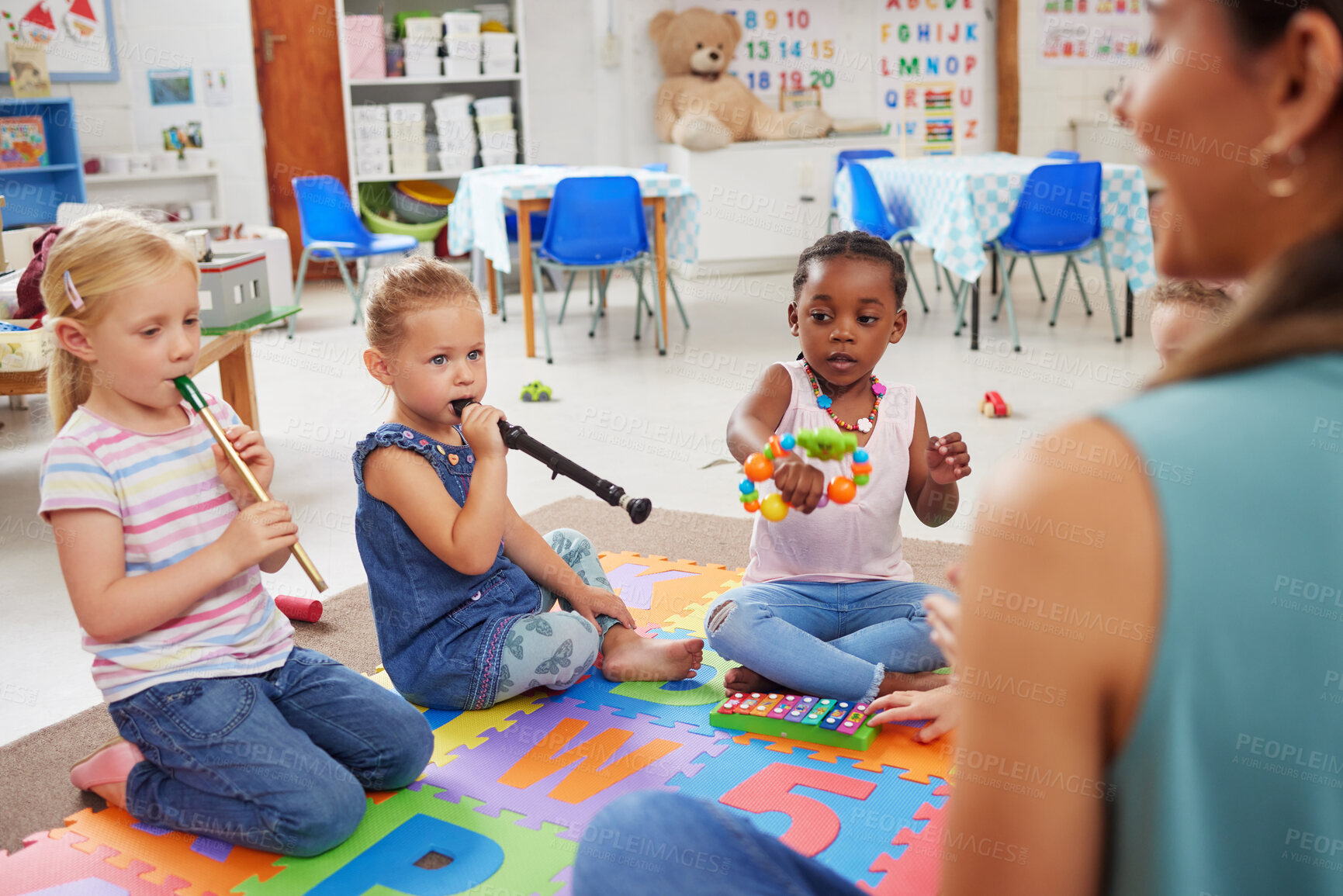 Buy stock photo Shot of children learning about musical instruments in class