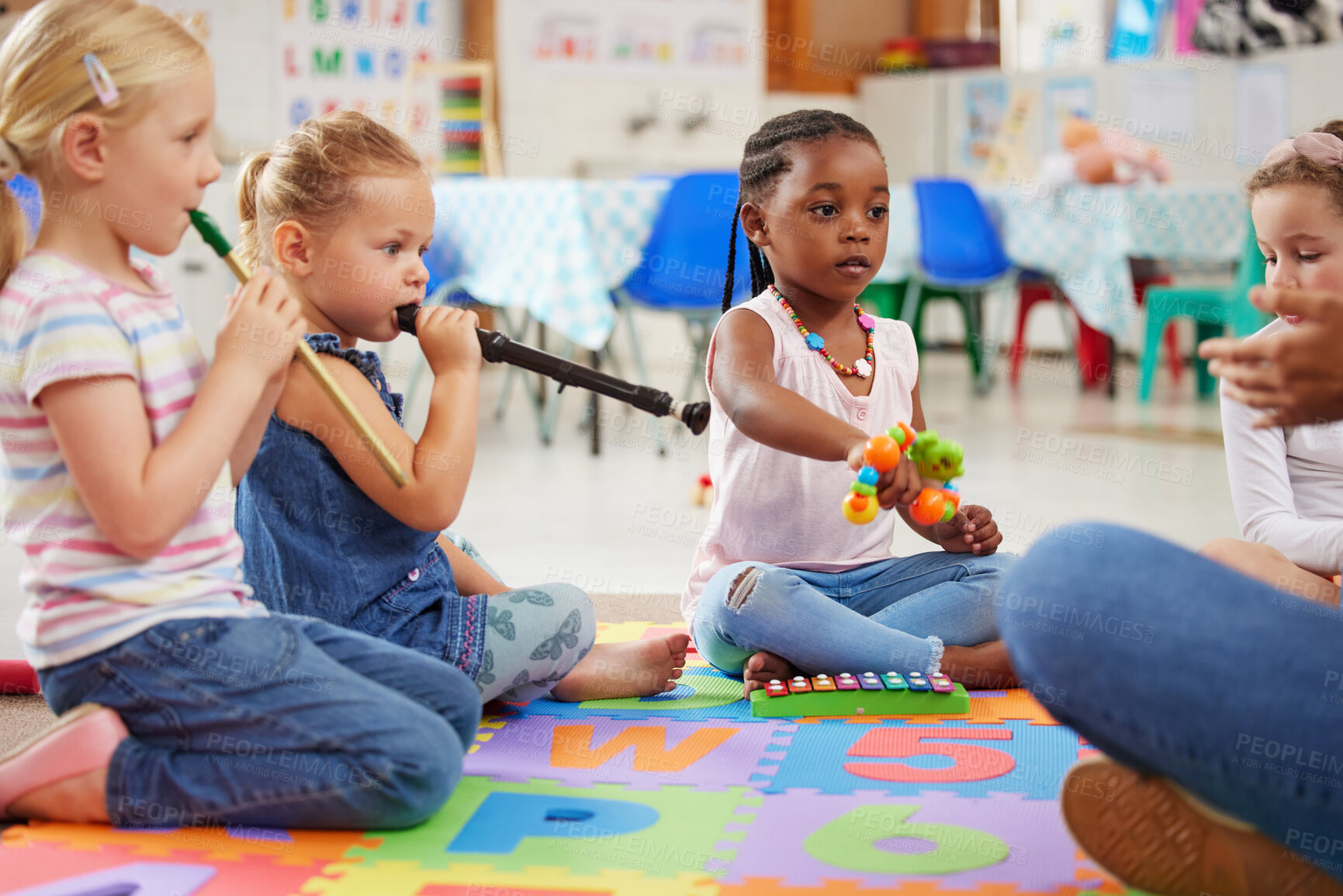 Buy stock photo Shot of children learning about musical instruments in class