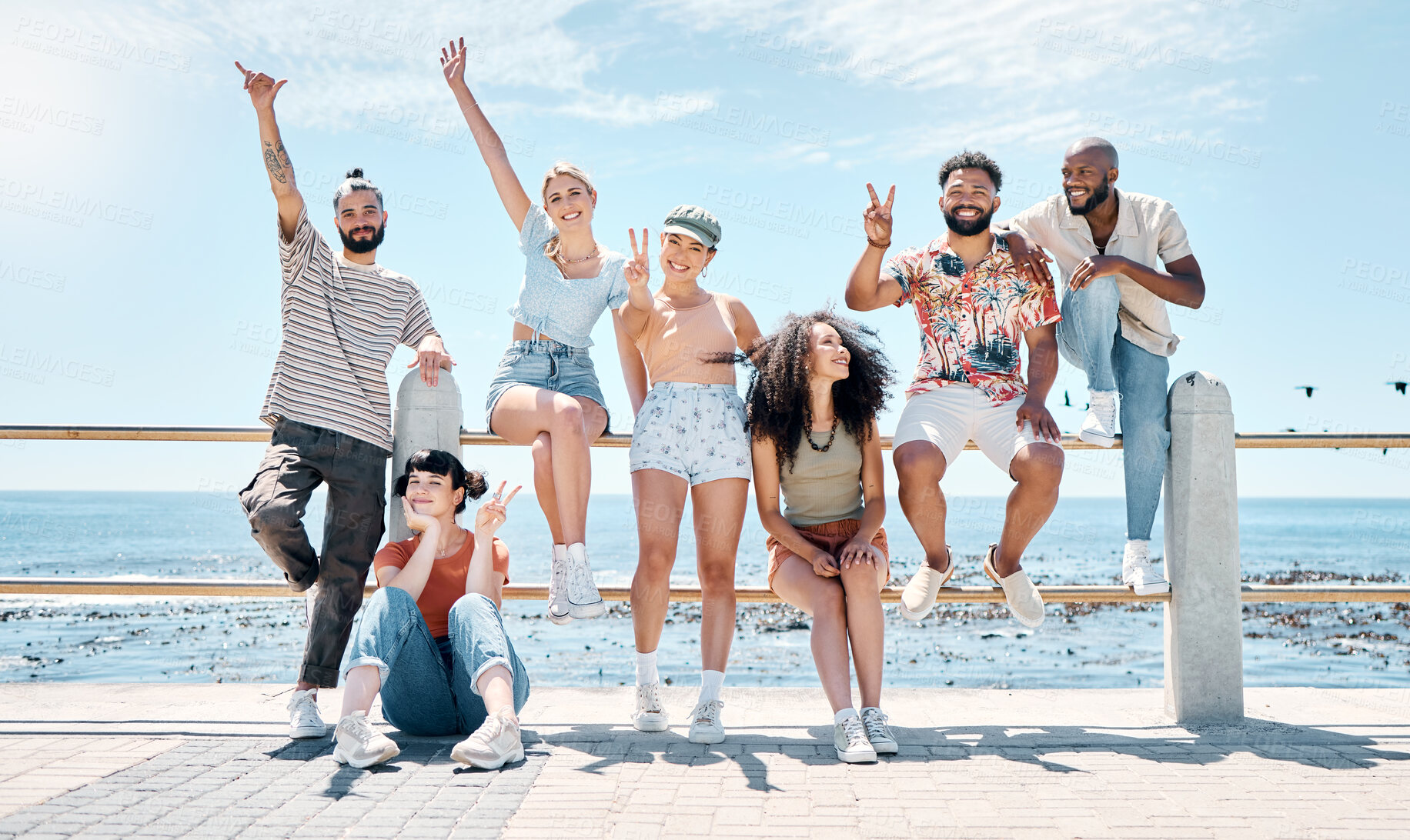 Buy stock photo Full length shot of a diverse group of friends bonding together during a day outdoors