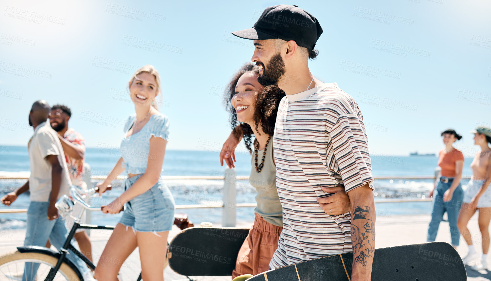 Buy stock photo Shot of a young couple waking together during a day outdoors with their friends