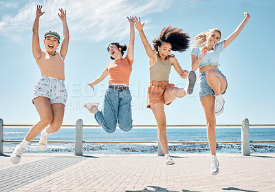 Buy stock photo Full length shot of a diverse group of women bonding during a day outdoors and jumping with excitement