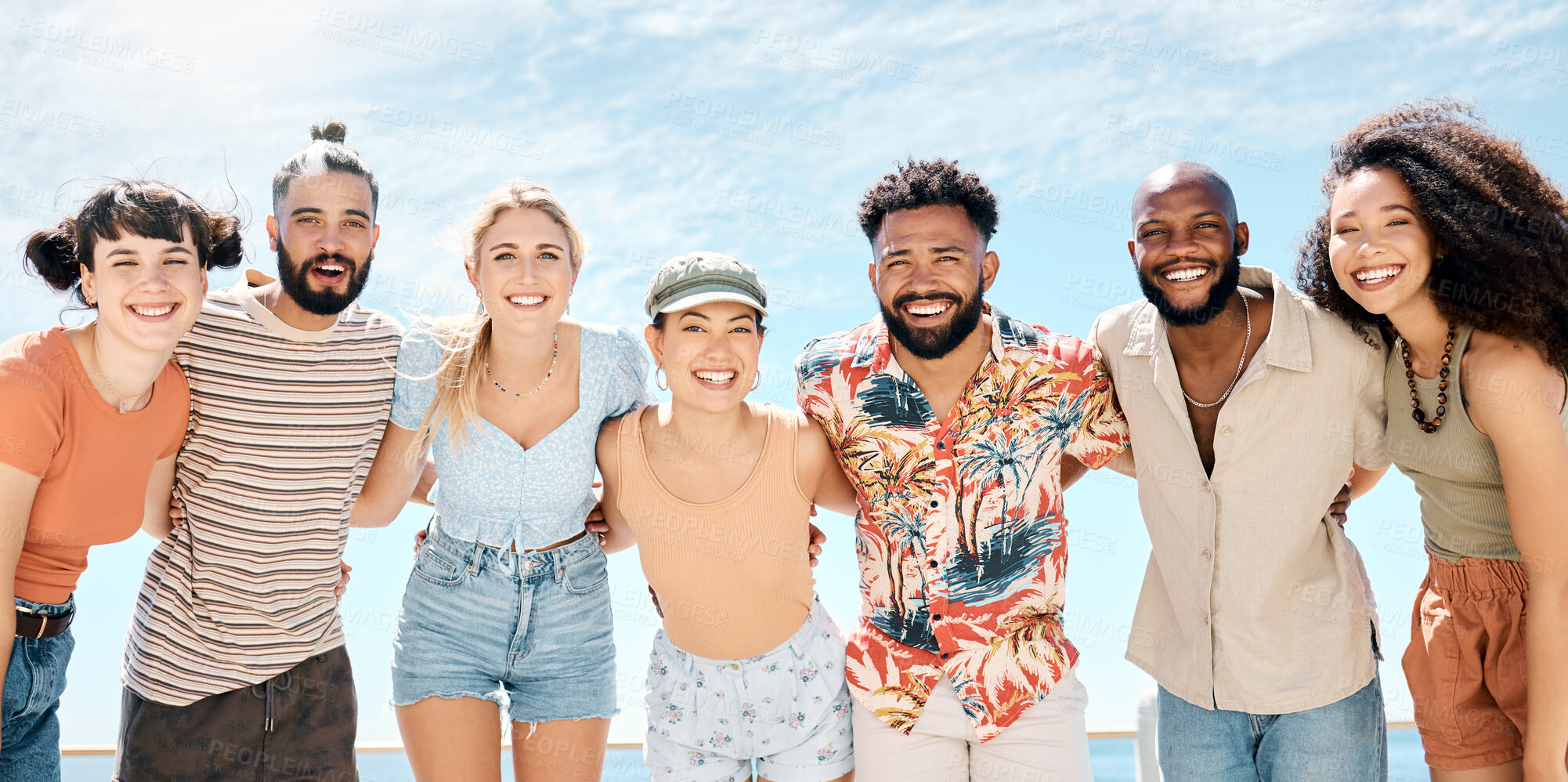 Buy stock photo Shot of a diverse group of friends standing together and bonding during a day outdoors