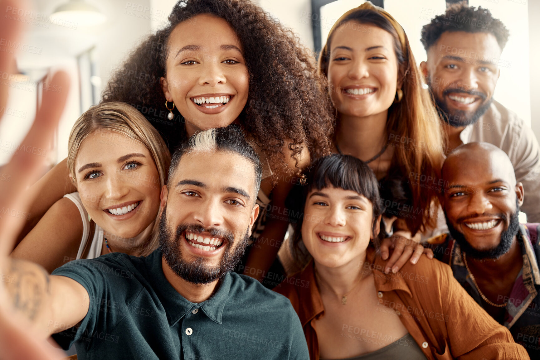 Buy stock photo Shot of a group of young friends taking selfies together at a restaurant