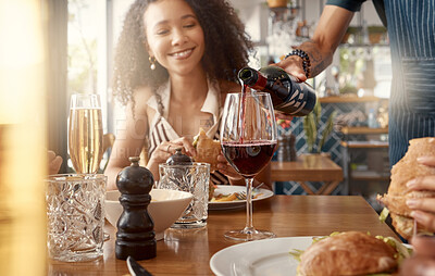 Buy stock photo Shot of a young woman having a glass of wine poured