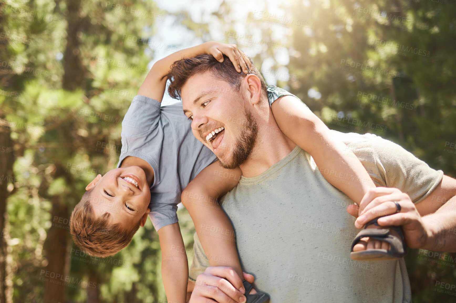 Buy stock photo Son, father and back in outdoors with portrait for happiness for bonding and fun in summer on the weekend. Adventure, man and boy on shoulders with smile in nature for childhood with love and care.