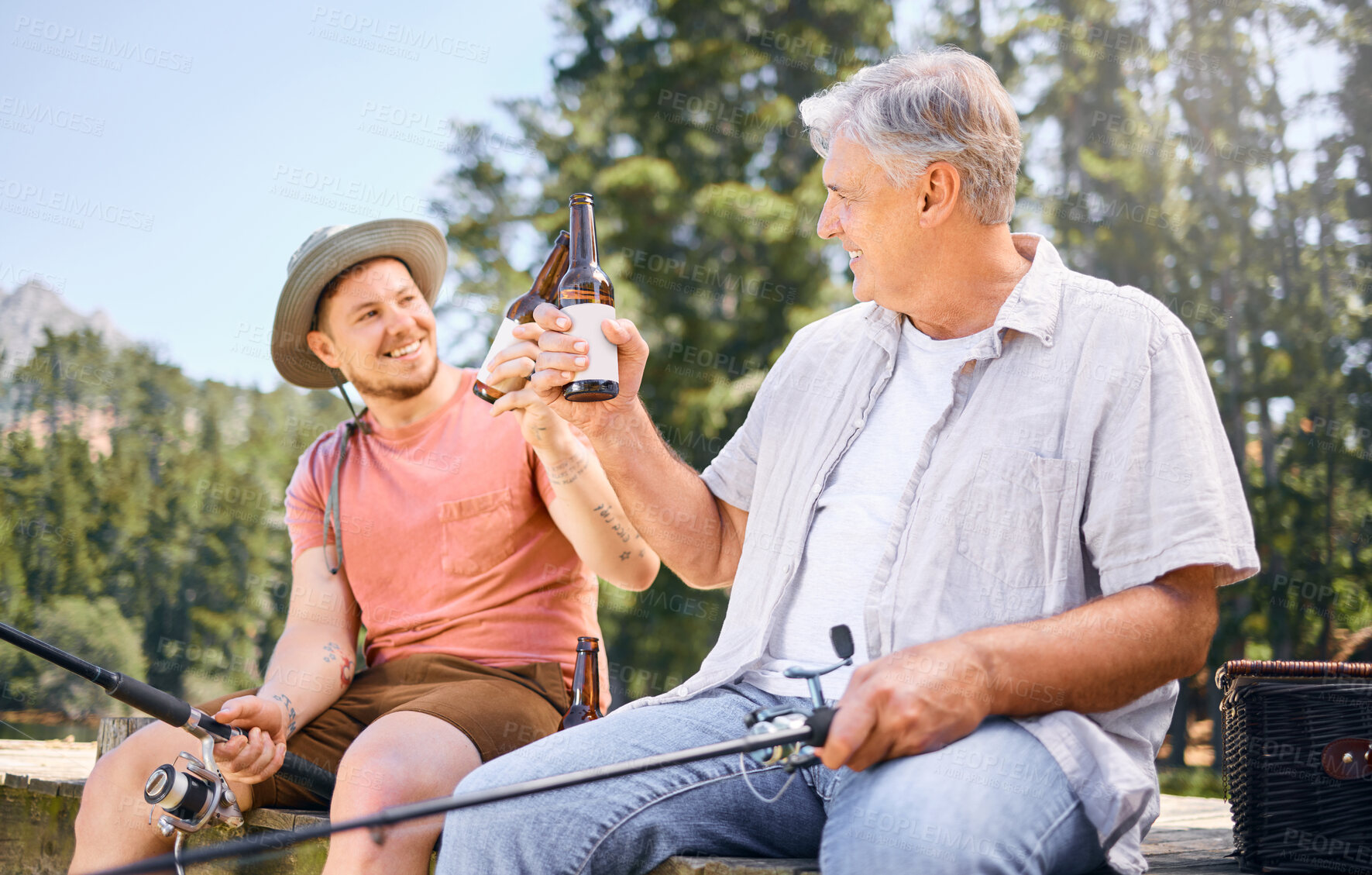 Buy stock photo Fishing, lake and senior male or son with drink for happiness or adventure at forest on vacation. Hobby, river and rod with man and grandfather with beer on holiday together for bonding in nature.