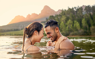 Buy stock photo Man, woman and hug with swim in lake, sunset and forest with love, bonding and vacation in summer. Young happy couple, outdoor and water for holiday together in sunshine with care, laugh or freedom