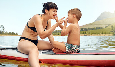 Buy stock photo Lake, nature with mother and son on paddle board, relax outdoor with summer holiday and travel. Adventure, freedom and fun, family with woman and boy child in swimsuit, vacation and bonding together