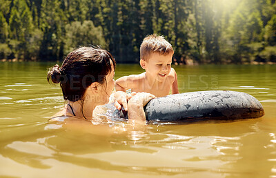 Buy stock photo Travel, float and mother with her child in lake swimming while on a summer vacation or adventure. Happy, tubing and young mom bonding with boy kid in outdoor pond on tropical weekend trip or holiday.