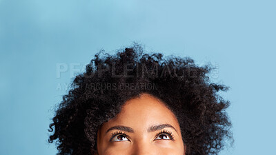 Buy stock photo Woman, looking up and mockup space for advertising, announcement and promo idea. Thinking, young female person face and eyes with blue background in studio with promotion deal and sale advert