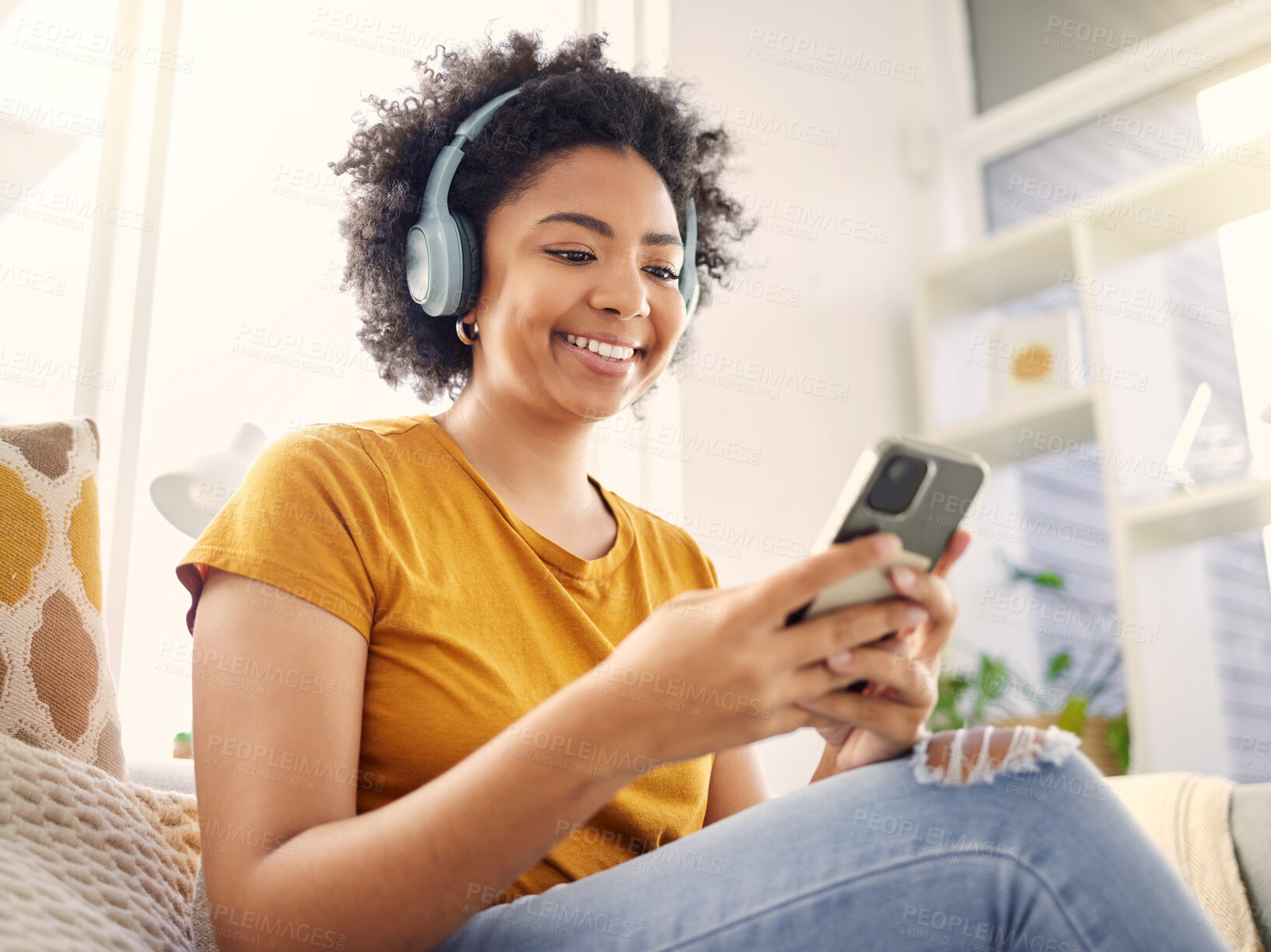 Buy stock photo Relax, couch and woman with a cellphone, headphones and happiness with stress relief, audio and streaming music. Happy, female person and girl on a sofa, headset and smartphone with wellness and song