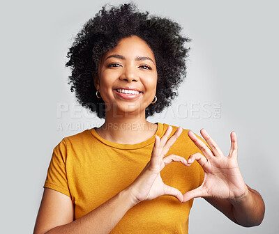 Buy stock photo Portrait, woman and smile with heart hands in studio, white background and care of kindness, emoji and icon. Happy young female model, love and finger shape for thank you, trust and hope of support