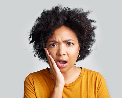 Buy stock photo Omg, wow and confused woman with hand on face in studio confused, surprised and open mouth on grey background. Wtf, portrait and African female shocked, by news, gossip or rumor, drama or secret