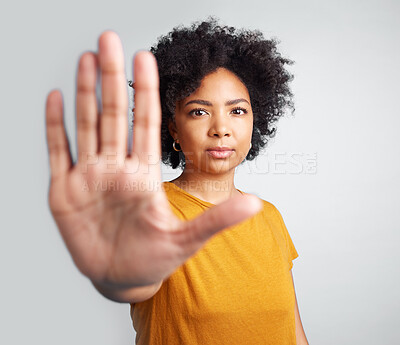 Buy stock photo Portrait, palm and warning with a woman in studio on a gray background for control or to stop abuse. Hand, protest and body language with an attractive young female person saying no in disagreement