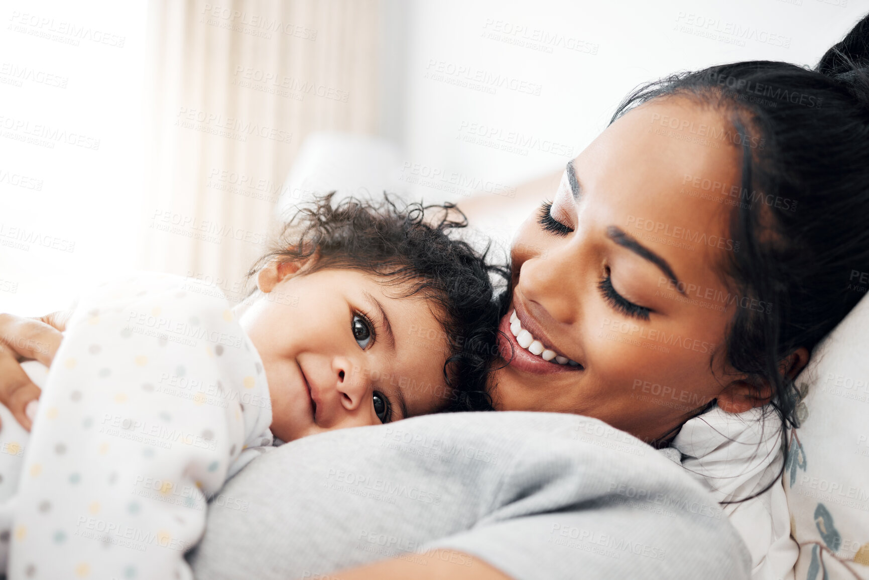 Buy stock photo Shot of a young woman cuddling her baby girl