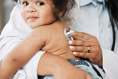 Buy stock photo Shot of a pediatrician listening to the heartbeat of her little patient