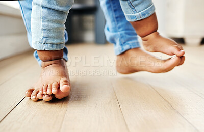 Buy stock photo Shot of a mother helping her baby learn to walk