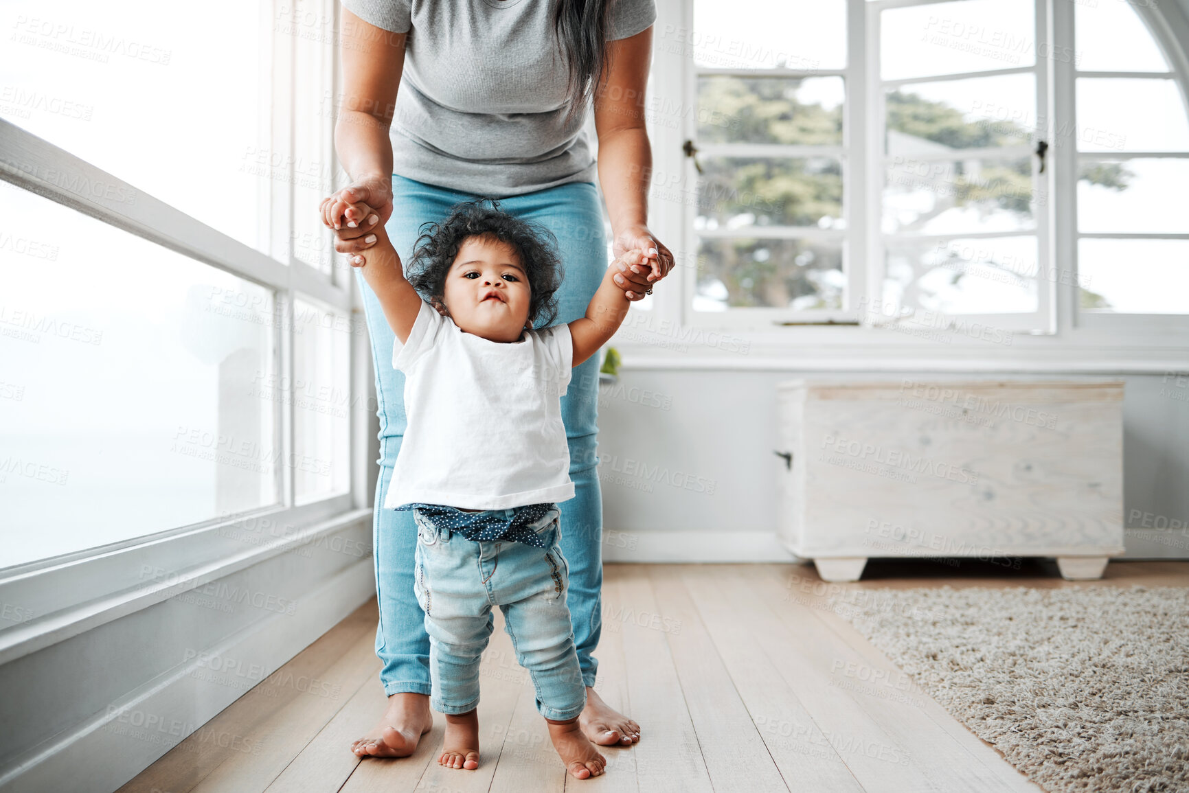 Buy stock photo Walking, learning and care with mother, baby and support for growth, development and motor skills. Female person, child and love in home or living room for bonding, together and teaching as family