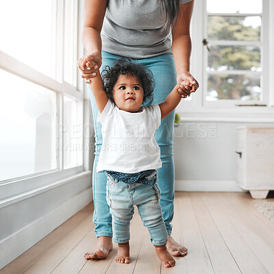 Buy stock photo Walking, teaching and care with mother, baby and support for growth, development and motor skills. Female person, child and love in home or living room for bonding together, learning and family home