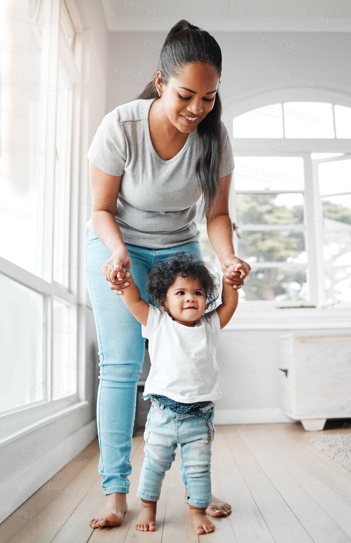 Buy stock photo Walking, teaching and love with mother, baby and support for growth, development or motor skills. Female person, child and care in house or living room for bonding together or learning in family home