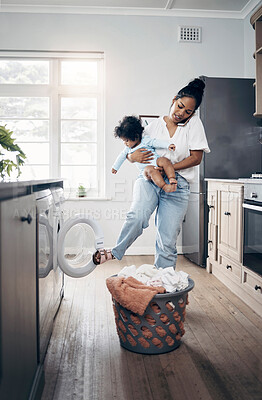 Buy stock photo Shot of a young mother using a cellphone while completing housework and holding her baby at home