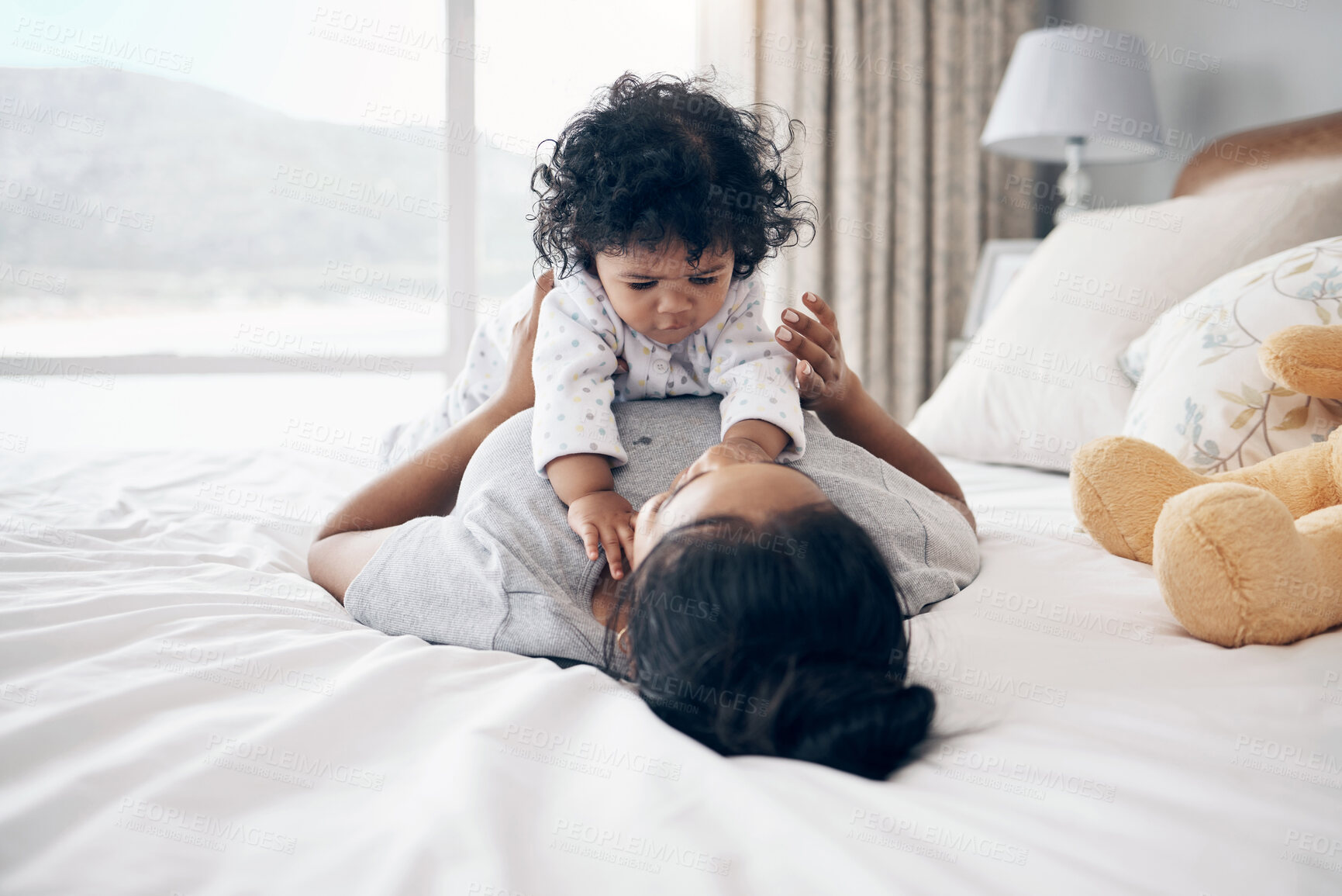 Buy stock photo Playing, mother and relax with baby on bed for bonding, child development and morning routine in home. Parenting, woman and infant in bedroom for wellness, protection and relationship with security