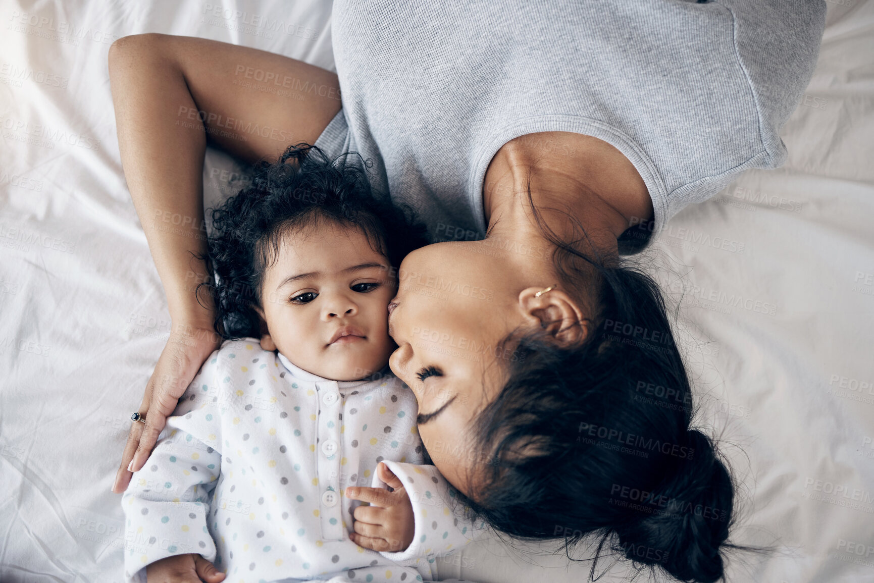 Buy stock photo Love, mother and kiss baby on bed for affection, child development and morning routine with bonding. Top view, woman and infant in bedroom with wellness, protection and relationship with connection