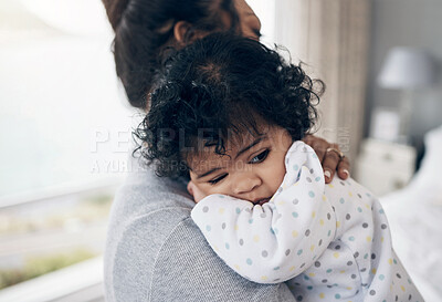 Buy stock photo Shot of a mother holding her baby daughter at home
