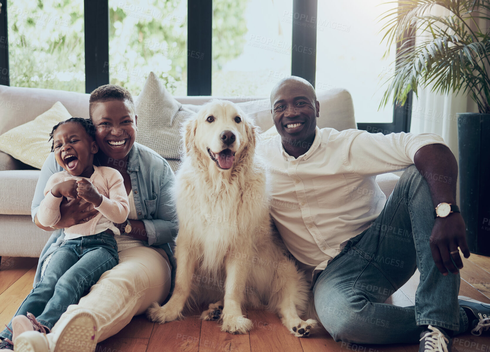 Buy stock photo Portrait, home and parents laughing with child, mother or dad in living room with love or support. Animal, African family or happy mom with father or girl kid with pet or golden retriever in Tanzania