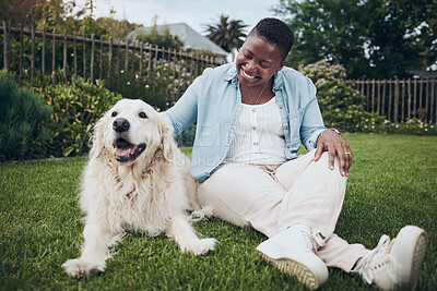 Buy stock photo Shot of an attractive young woman petting her dog in the garden